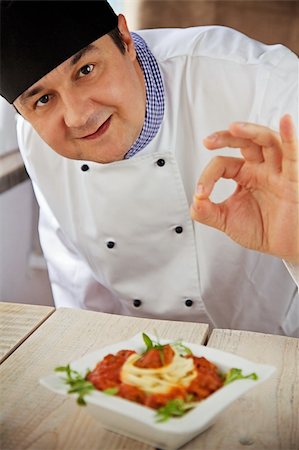 Male chef in restaurant kitchen is garnishing and preparing pasta dish Stock Photo - Budget Royalty-Free & Subscription, Code: 400-06384069