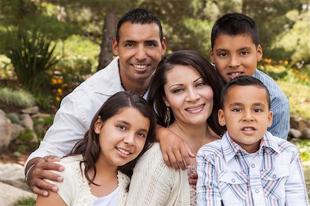 Happy Attractive Hispanic Family Portrait Outdoors In the Park. Stock Photo - Budget Royalty-Free & Subscription, Code: 400-06384255