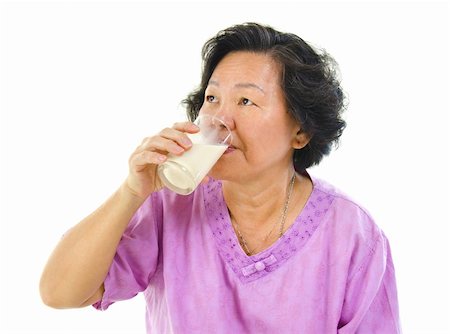 Asian senior woman drinking a glass of soy milk over white background Stock Photo - Budget Royalty-Free & Subscription, Code: 400-06387429