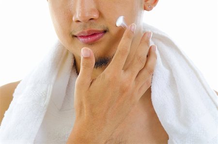 Asian man putting on cream lotion on face Stock Photo - Budget Royalty-Free & Subscription, Code: 400-06387437