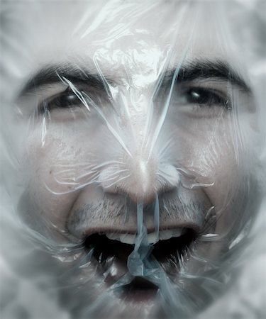 Young man close up with a plastic bag on his head-NOTE:Soft blur was added to simulate a ghost effect. Stock Photo - Budget Royalty-Free & Subscription, Code: 400-06387913