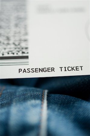 Airline ticket on knees of a passenger. Tilt shift lens used to accent passenger ticket text and jeans Stock Photo - Budget Royalty-Free & Subscription, Code: 400-06388814