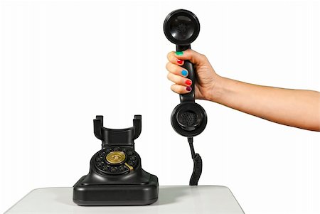 simsearch:400-07038627,k - A hand holding the handset of an old black vintage rotary style telephone isolated over white. Stock Photo - Budget Royalty-Free & Subscription, Code: 400-06389073