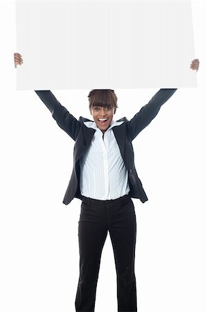 Excited businesswoman poisng with billboard isolated on white Stock Photo - Budget Royalty-Free & Subscription, Code: 400-06389496