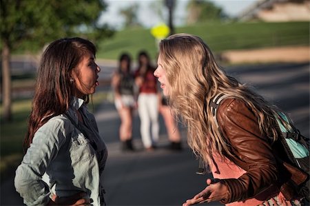 Two serious teenage female students arguing outside Stock Photo - Budget Royalty-Free & Subscription, Code: 400-06394250