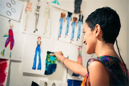 Young people and small business, hispanic woman at work as fashion designer and tailor, looking at sketches of new collection in atelier Stock Photo - Budget Royalty-Free & Subscription, Code: 400-06395405