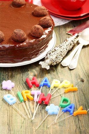 Chocolate cake and candles in the form of letters "Happy Birthday." Stock Photo - Budget Royalty-Free & Subscription, Code: 400-06395477