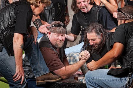 simsearch:400-06396842,k - Big man in biker gang losing arm wrestling match Stock Photo - Budget Royalty-Free & Subscription, Code: 400-06396547