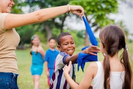 People and fun, group of male and female school kids with young woman working as educator playing game outdoor at summer camp Stock Photo - Budget Royalty-Free & Subscription, Code: 400-06396552