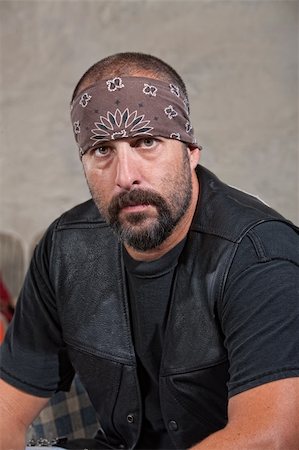 simsearch:400-06741204,k - Serious bearded man with bandana and leather vest Stock Photo - Budget Royalty-Free & Subscription, Code: 400-06396854