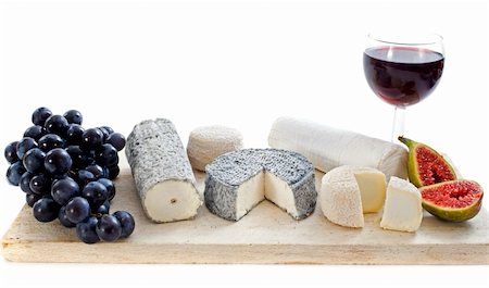 various of local speciality goat cheese, fruits and glass of wine in front of white background Stock Photo - Budget Royalty-Free & Subscription, Code: 400-06396924