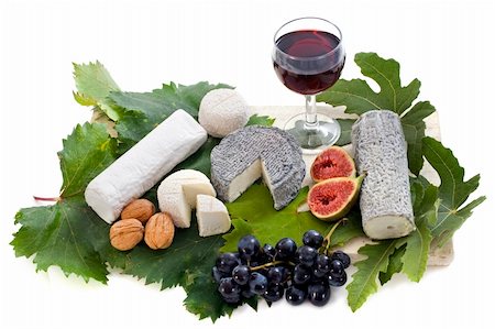various of local speciality goat cheese, fruits and glass of wine in front of white background Stock Photo - Budget Royalty-Free & Subscription, Code: 400-06396925
