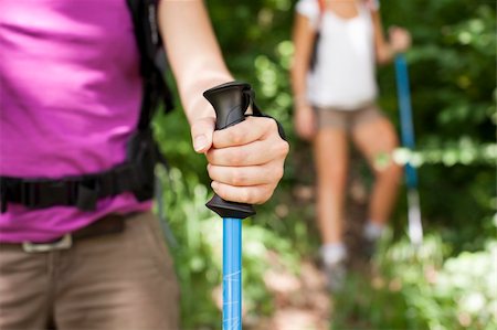 simsearch:400-06396994,k - young female friends walking in woods. Closeup of hand holding stick Stock Photo - Budget Royalty-Free & Subscription, Code: 400-06396996