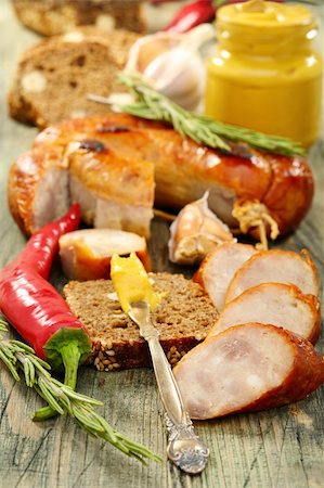 Rye bread with sausage and mustard on the old board. Fotografie stock - Microstock e Abbonamento, Codice: 400-06390753