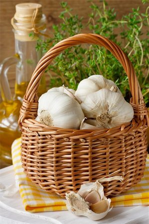 Garlic in a wicker basket on a kitchen board. Stock Photo - Budget Royalty-Free & Subscription, Code: 400-06391319