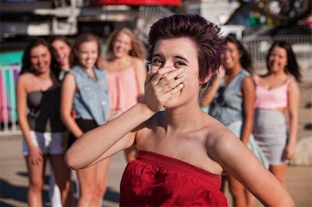 simsearch:400-05285711,k - Female Hispanic teenager covering her mouth while laughing Stock Photo - Budget Royalty-Free & Subscription, Code: 400-06391953