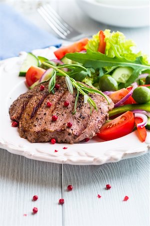 grilled beef steak  with mediterranean-style salad on a plate Stock Photo - Budget Royalty-Free & Subscription, Code: 400-06392130