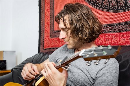 An image of a handsome guitar player with a curly hairdo Foto de stock - Super Valor sin royalties y Suscripción, Código: 400-06393456