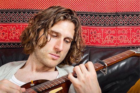 An image of a handsome guitar player with a curly hairdo Stock Photo - Budget Royalty-Free & Subscription, Code: 400-06393458