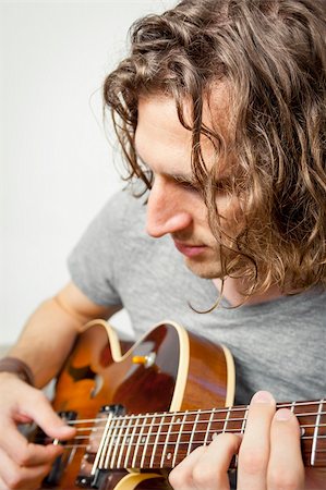 An image of a handsome man playing the guitar Stock Photo - Budget Royalty-Free & Subscription, Code: 400-06393453