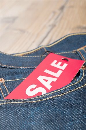 reduced sign in a shop - Red Sale Tag in Pocket of Blue Jeans Stock Photo - Budget Royalty-Free & Subscription, Code: 400-06393524