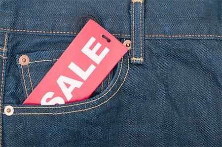 reduced sign in a shop - Red Sale Tag in Pocket of Blue Jeans Stock Photo - Budget Royalty-Free & Subscription, Code: 400-06393523