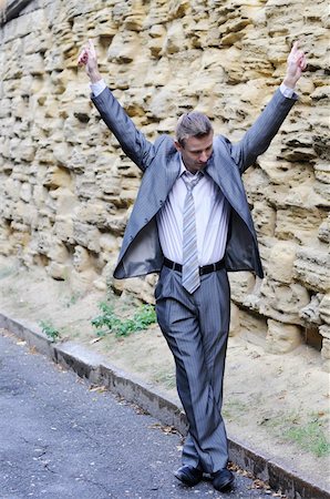 simsearch:400-06393704,k - happy businessman dancing in the street against the wall Stock Photo - Budget Royalty-Free & Subscription, Code: 400-06393706