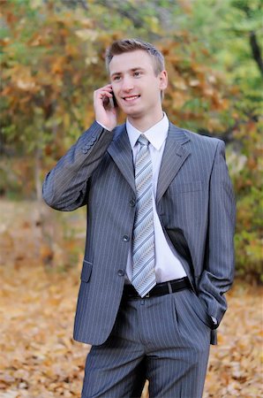 simsearch:400-06393704,k - businessman talks on the phone  in the autumn park Stock Photo - Budget Royalty-Free & Subscription, Code: 400-06393728