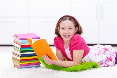 school girl holding pile of books - Happy young girl reading a book - back to learning and school Stock Photo - Budget Royalty-Free & Subscription, Code: 400-06408448