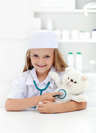 Little girl playing veterinary - examining her toy with stethoscope Stock Photo - Budget Royalty-Free & Subscription, Code: 400-06408537