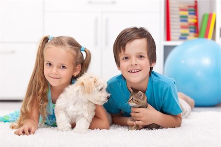 simsearch:400-07168060,k - Happy kids with their pets - a dog and a kitten, laying on the floor Stock Photo - Budget Royalty-Free & Subscription, Code: 400-06408530