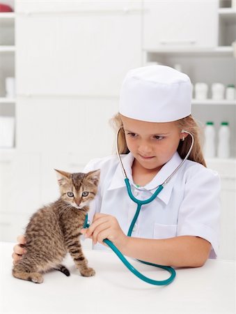 simsearch:400-08372788,k - Little girl playing at the veterinary - consulting her little kitten Stock Photo - Budget Royalty-Free & Subscription, Code: 400-06408546