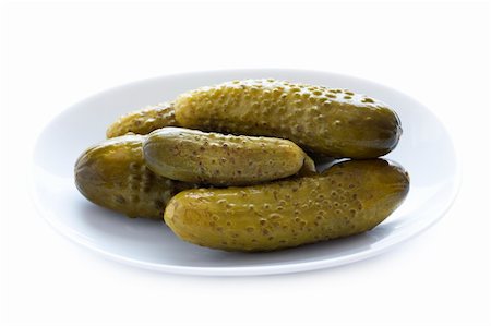 pickling gherkin - pickled gherkins or gerkins isolated in a dish Stock Photo - Budget Royalty-Free & Subscription, Code: 400-06415537