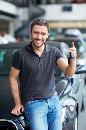 The young man with the keys in the showroom Stock Photo - Budget Royalty-Free & Subscription, Code: 400-06415904