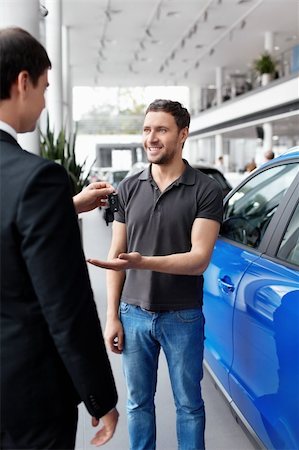 Seller gives buyer the keys inside the car Stock Photo - Budget Royalty-Free & Subscription, Code: 400-06415909