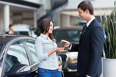 simsearch:400-06415950,k - Seller gives keys to car girl in the salon Stock Photo - Budget Royalty-Free & Subscription, Code: 400-06415916