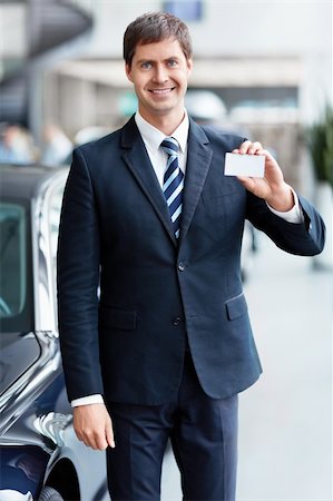 Seller with a business card in the showroom Stock Photo - Budget Royalty-Free & Subscription, Code: 400-06415933