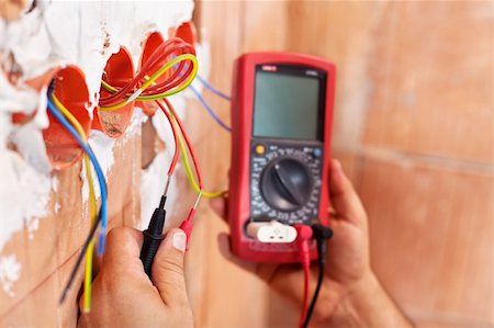 Electrician working with measuring instrument and wires - closeup on hands Stock Photo - Budget Royalty-Free & Subscription, Code: 400-06416295