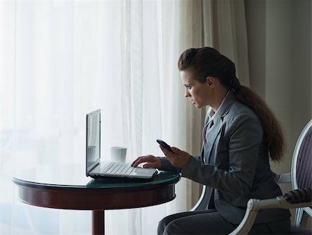 Business woman working on laptop in hotel room Stock Photo - Budget Royalty-Free & Subscription, Code: 400-06416381