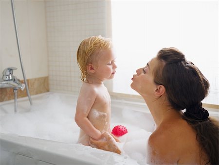 Baby kissing mother while washing in foam filled bathtub Stock Photo - Budget Royalty-Free & Subscription, Code: 400-06416408
