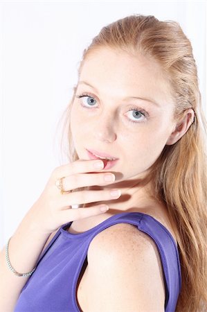 Young and beautiful redhead woman posing at the studio, with purple dress Stock Photo - Budget Royalty-Free & Subscription, Code: 400-06416432