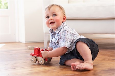 Young Boy Playing With Wooden Toy Car At Home Stock Photo - Budget Royalty-Free & Subscription, Code: 400-06417516