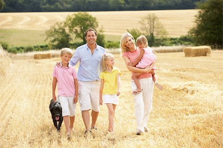 Family Walking Together Through Summer Harvested Field Stock Photo - Budget Royalty-Free & Subscription, Code: 400-06417580