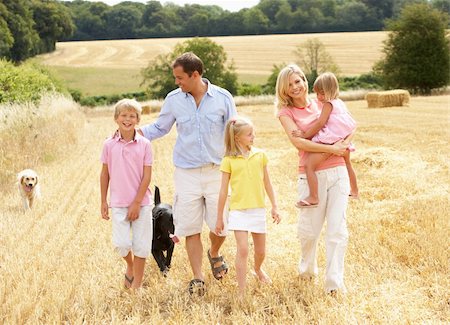 Family Walking Together Through Summer Harvested Field Stock Photo - Budget Royalty-Free & Subscription, Code: 400-06417581