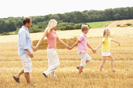 Family Walking Together Through Summer Harvested Field Stock Photo - Budget Royalty-Free & Subscription, Code: 400-06417647