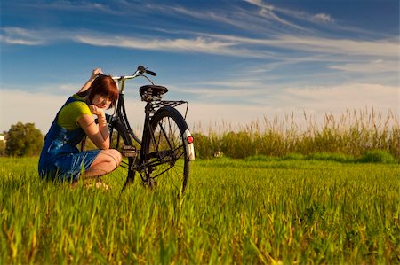 Young woman really anoyed beacuse of her to broken bicycle Stock Photo - Budget Royalty-Free & Subscription, Code: 400-06417916