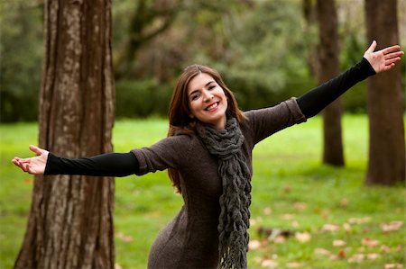people with forest background - Portrait of a beautiful young woman relaxing with arms open and enjoying the nature Stock Photo - Budget Royalty-Free & Subscription, Code: 400-06417953