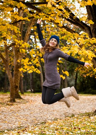 Beautiful and happy woman jumping in a autumn day Stock Photo - Budget Royalty-Free & Subscription, Code: 400-06417960