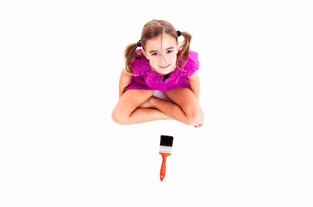 Top view of a happy girl sitting on floor holding a paint-brush Stock Photo - Budget Royalty-Free & Subscription, Code: 400-06417988