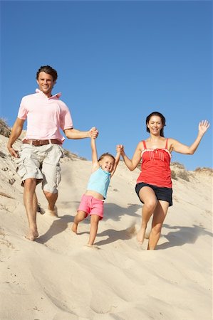 running sand dune - Family Enjoying Beach Holiday Running Down Dune Stock Photo - Budget Royalty-Free & Subscription, Code: 400-06418490